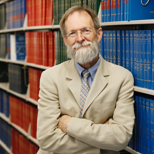 Daniel Martin standing in front of library book stacks.